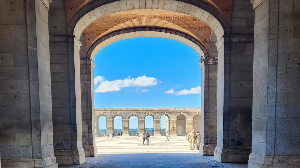 Plaza de la Armería with the Royal Palace in Madrid on a sunny day with visitors