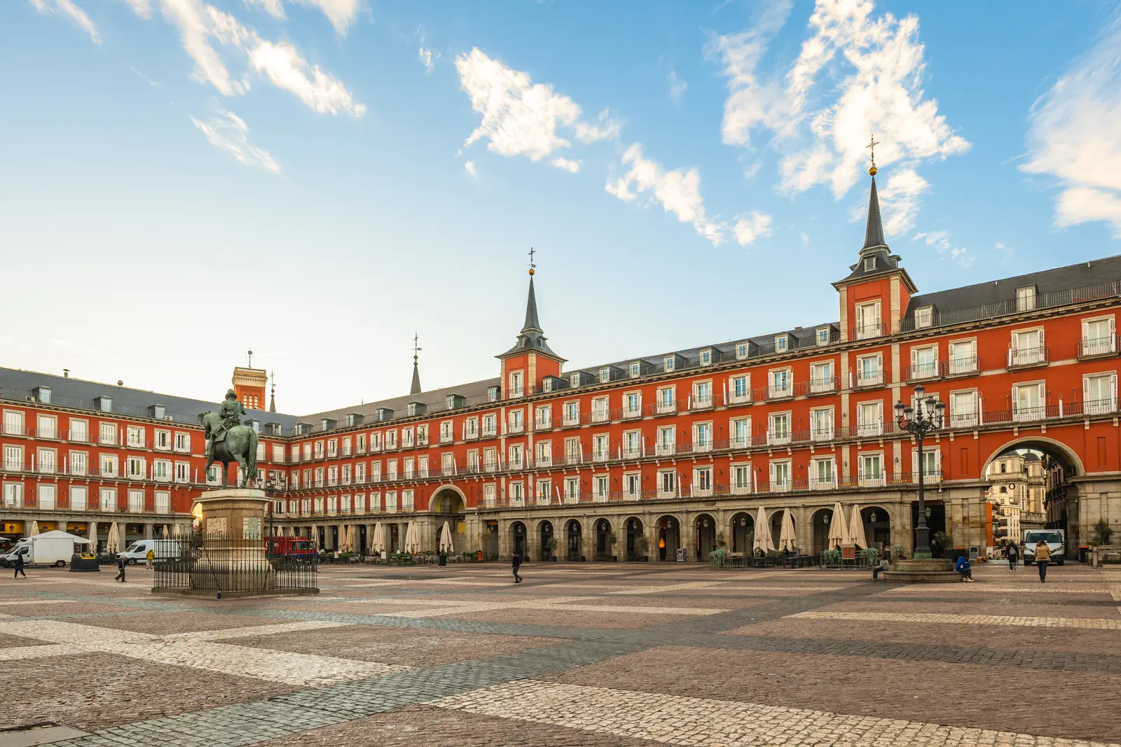 Panoramic view of Plaza Mayor in Madrid showing the full scale of the square with terracotta buildings, arcades, and 237 balconies