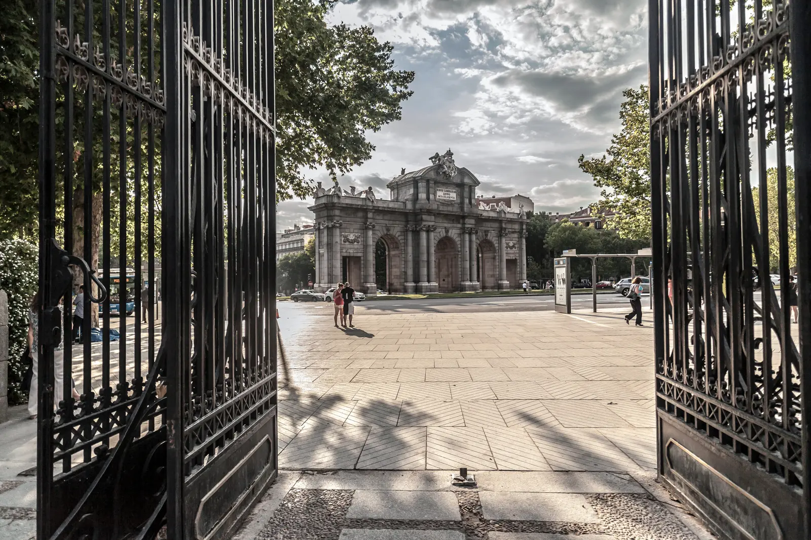 View of the Puerta de Alcalá from the wrought-iron gates of El Retiro Park in Madrid