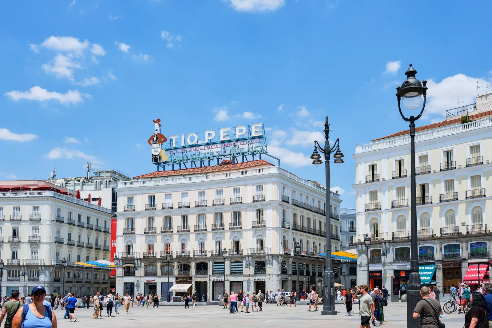 Puerta del Sol in Madrid alive with crowds, street performers, and the vibrant tempo of daily life