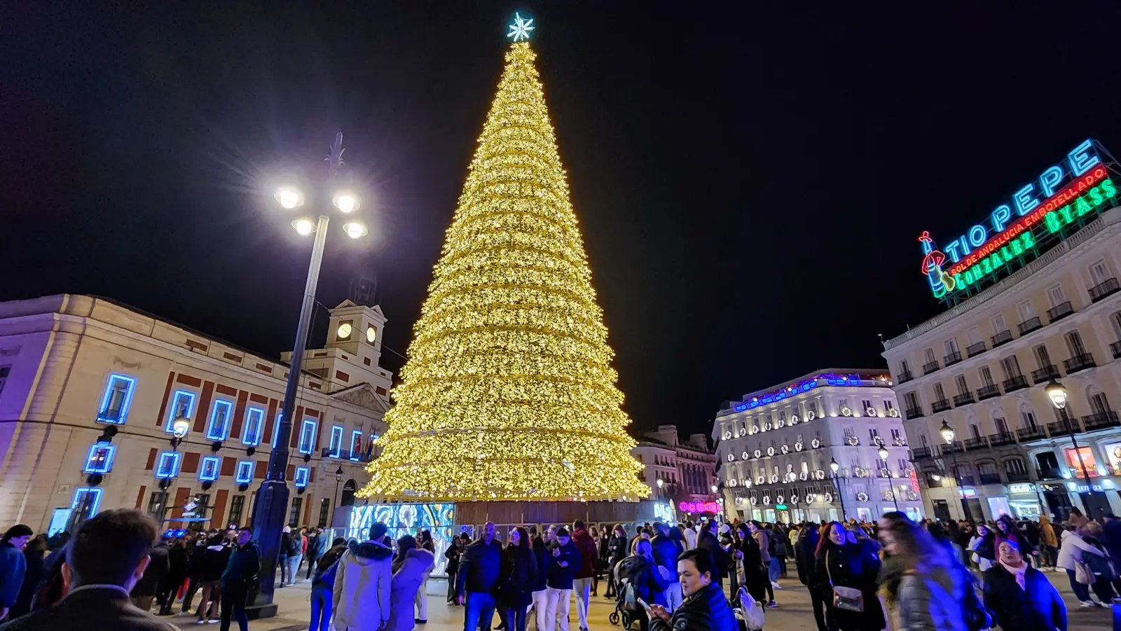Puerta del Sol in Madrid at evening with illuminated buildings and the square's atmospheric glow