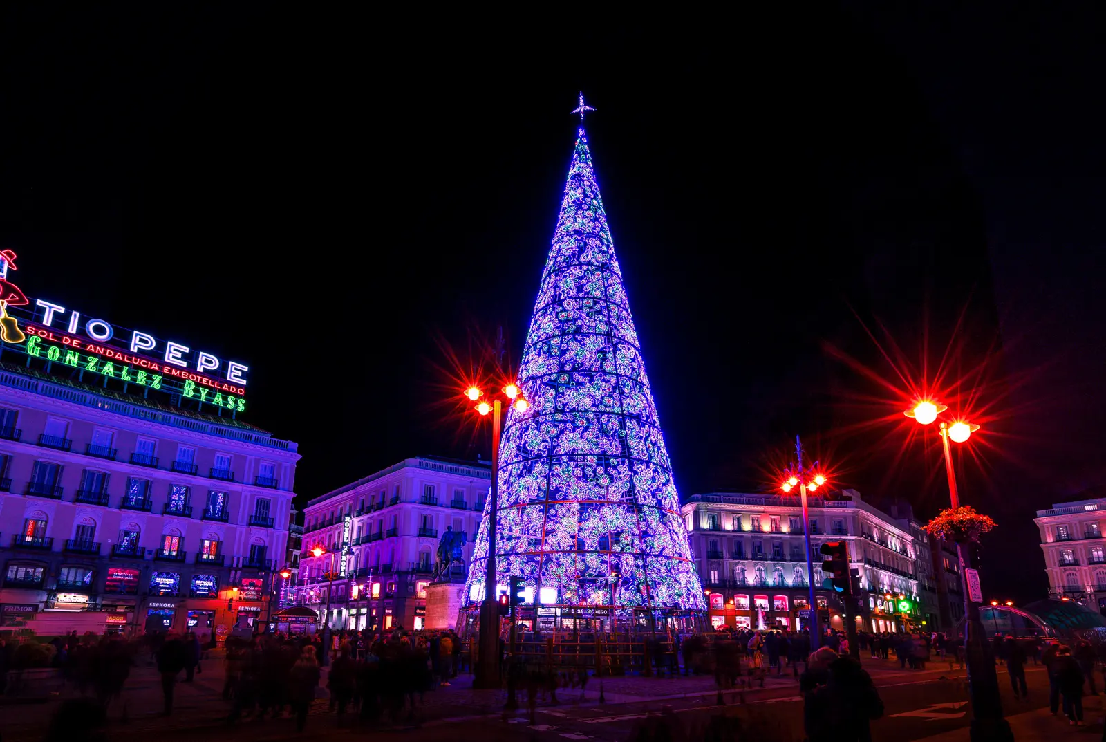 Puerta del Sol square in Madrid at ground level, showing the historic facades and the lively pedestrian atmosphere