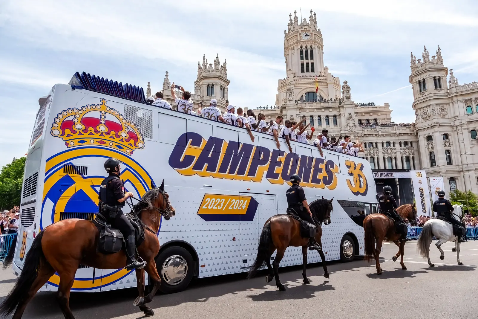 Real Madrid celebrations at Plaza de Cibeles with fans in white surrounding the Fountain of Cybele