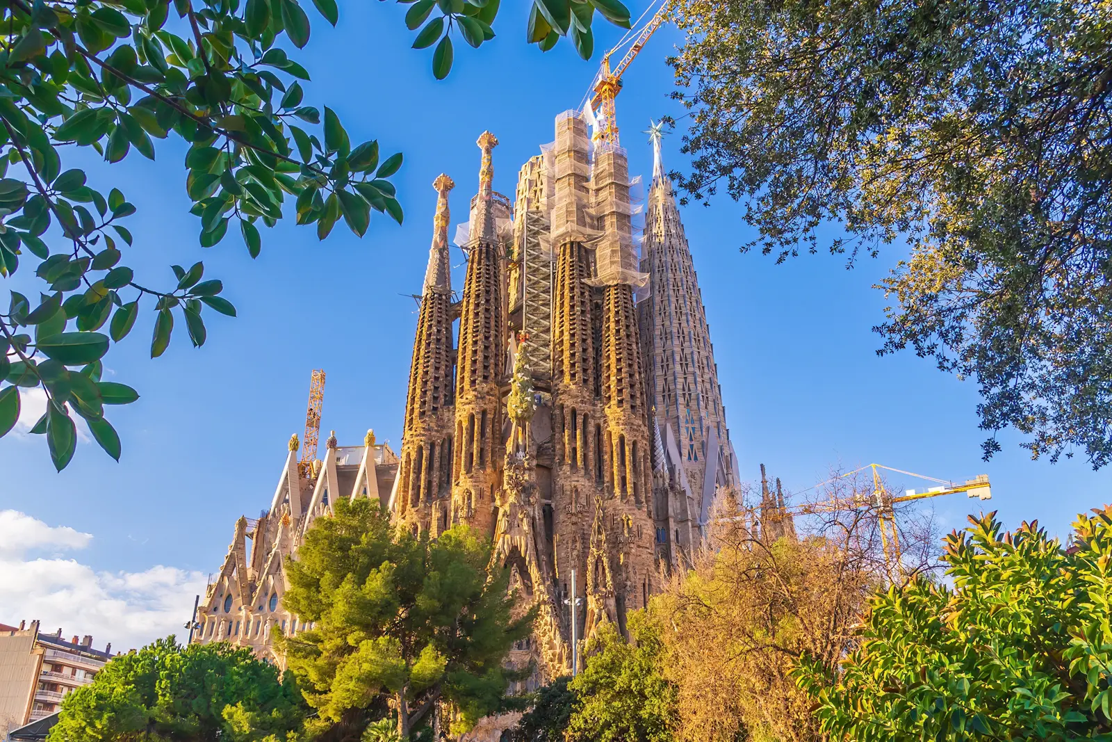 The Sagrada Família in Barcelona, Antoni Gaudí's unfinished masterpiece with its soaring spires, intricate Nativity facade, and construction cranes that have become part of its silhouette since 1882