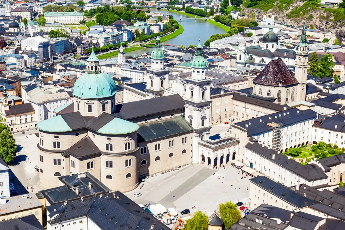 Aerial view of Salzburg Cathedral's green-domed Baroque exterior and Domplatz seen from Hohensalzburg Fortress, Salzburg, Austria