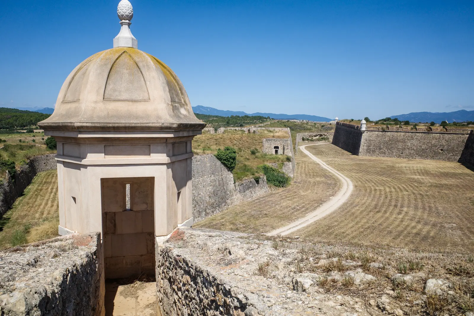 The imposing 18th-century Sant Ferran Castle in Figueres, one of the largest military bastions in Europe, with its vast star-shaped fortifications stretching across the Catalan landscape