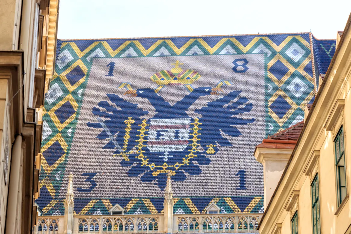 Imperial double-headed eagle and Habsburg coat of arms tile mosaic with the year 1831 on the south transept roof of St. Stephen's Cathedral in Vienna