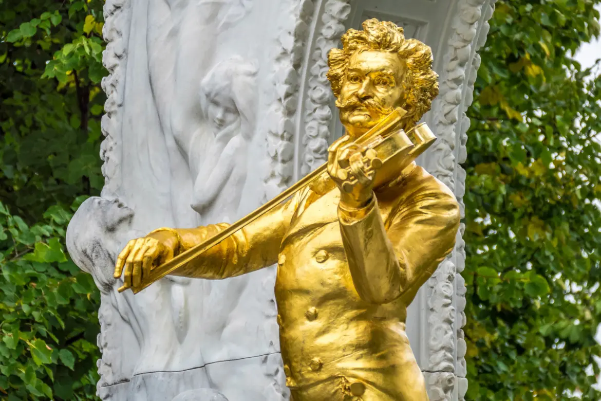Close-up of the gilded Johann Strauss II monument in Vienna's Stadtpark playing the violin