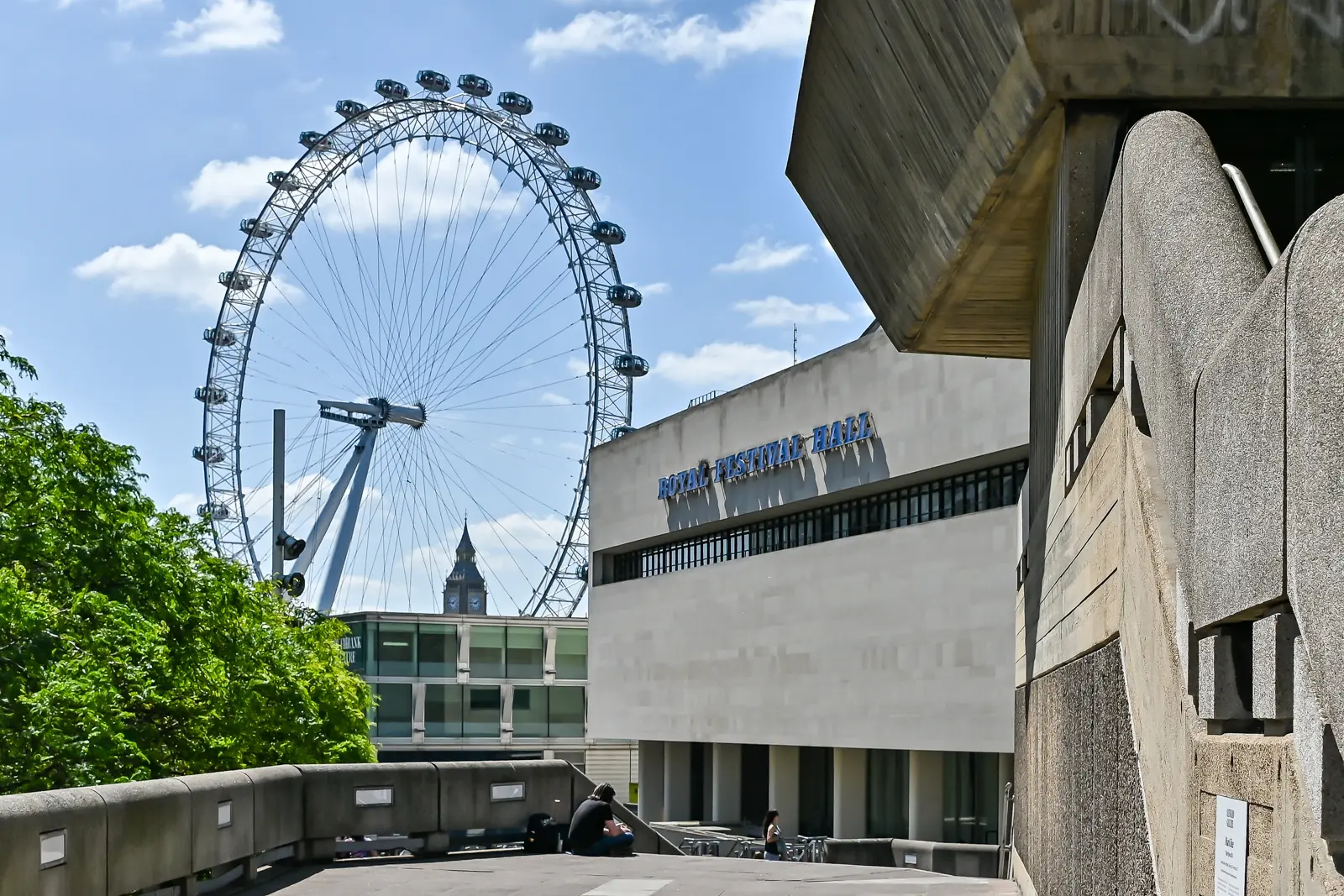 The Royal Festival Hall, the only surviving building from the 1951 Festival of Britain, with the London Eye and the Elizabeth Tower (Big Ben) visible behind. The brutalist concrete forms on the right belong to the Queen Elizabeth Hall and Hayward Gallery, added to the Southbank Centre site in 1967