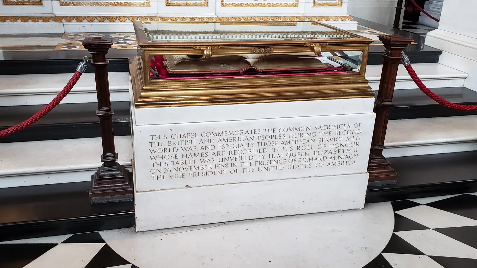 Marble plinth and gilded display case holding the Roll of Honour in the American Memorial Chapel at St Paul's Cathedral, with the inscription marking its unveiling by Queen Elizabeth II on 26 November 1958