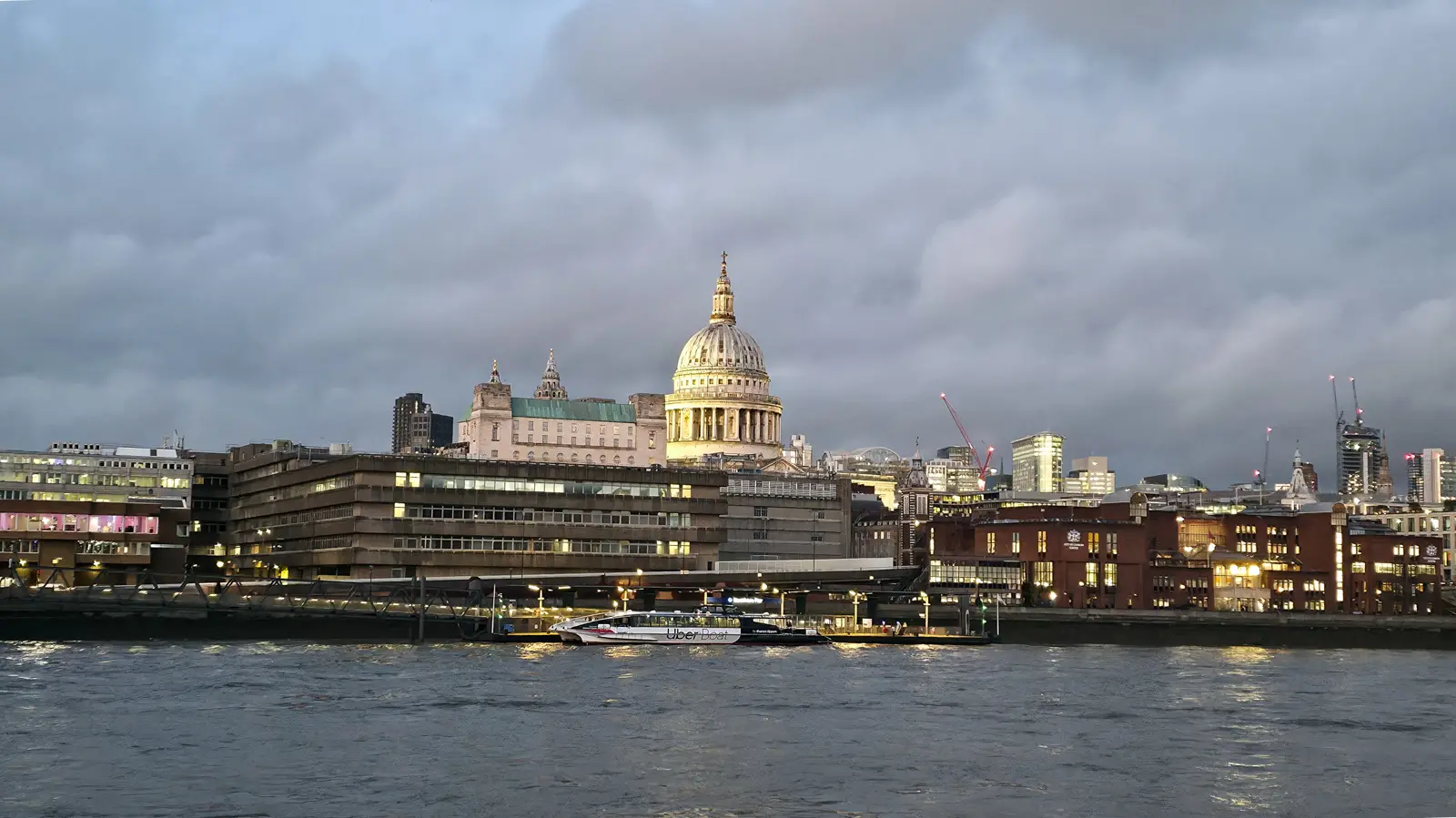 View of the iconic dome of St Paul's Cathedral rising above the River Thames in London, showcasing one of the city's most historic and recognizable skyline landmarks