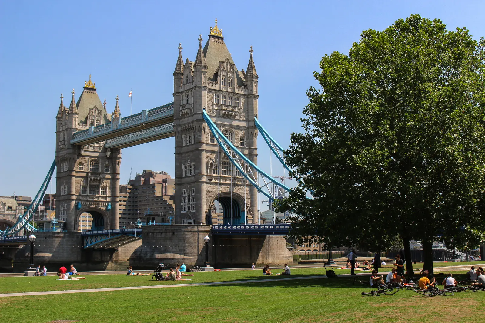 View of Tower Bridge from Potters Fields Park along the River Thames in London, where historic Victorian architecture meets the vibrant riverside atmosphere of modern London