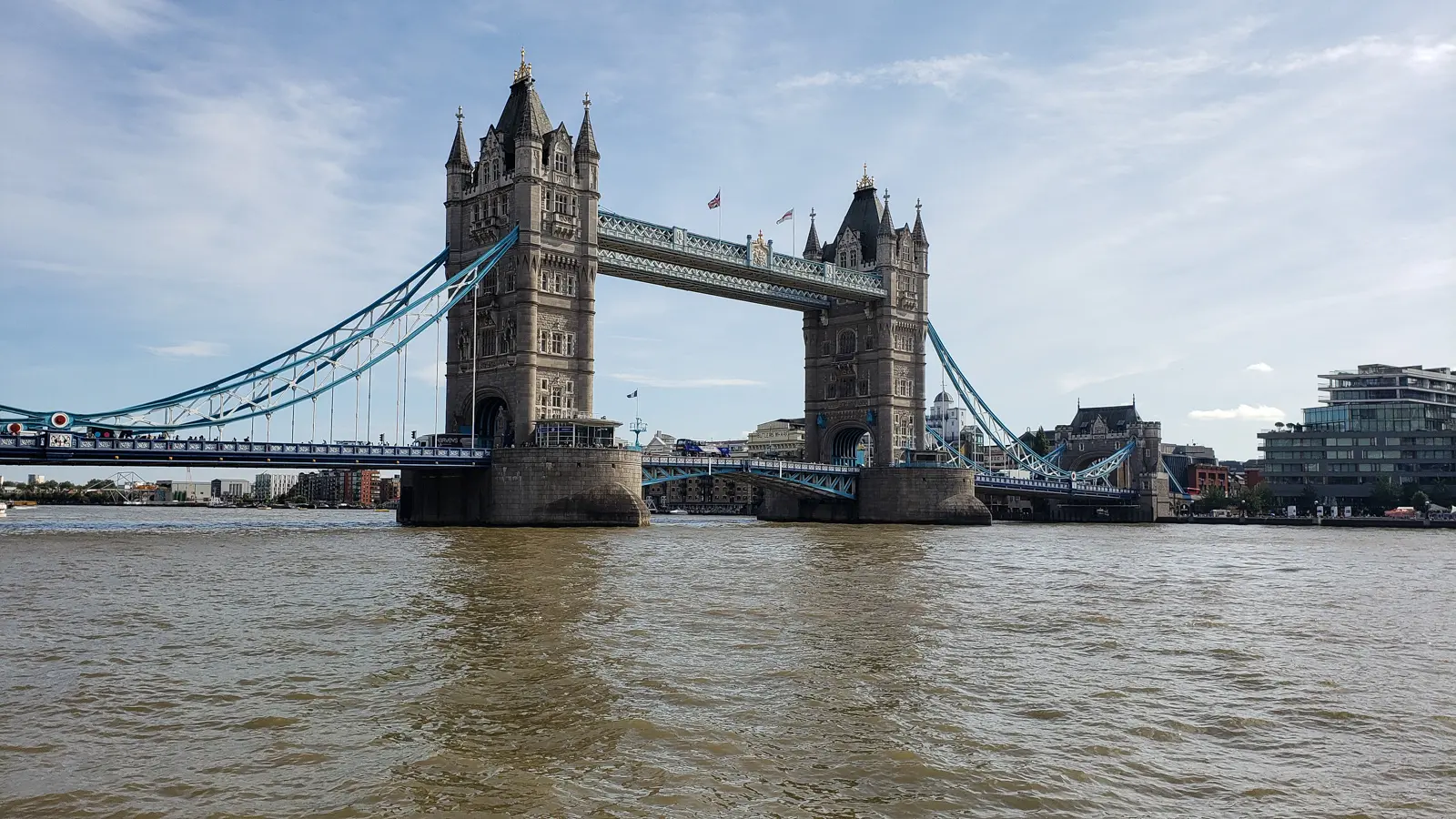 View of Tower Bridge rising above the River Thames in London, where Victorian engineering and Gothic Revival architecture continue to define one of the city's most iconic river crossings