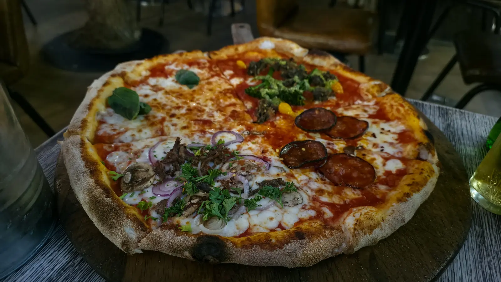 A bottomless pizza at Street Pizza by Gordon Ramsay, London, cut into slices that each carry a different topping