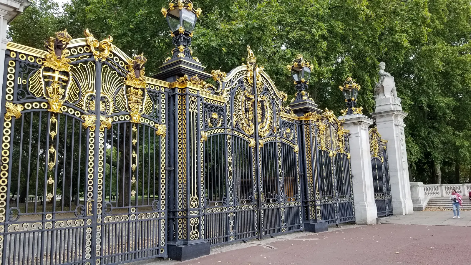 Ornate black-and-gold ironwork of Canada Gate, the entrance to Green Park beside the palace