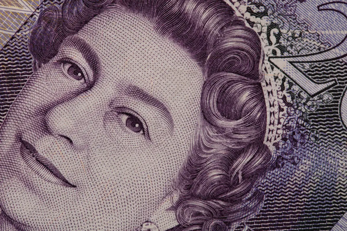 A macro close-up of the engraved portrait of Queen Elizabeth II on a purple Canadian twenty-dollar banknote