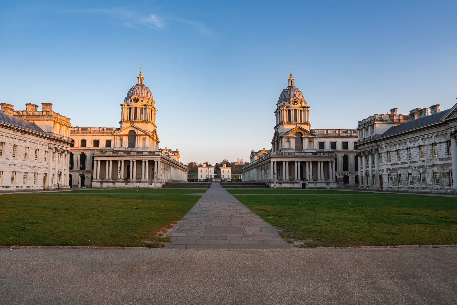 The twin domes of the Old Royal Naval College at Greenwich framing a central vista to the Queen’s House, with green lawns either side