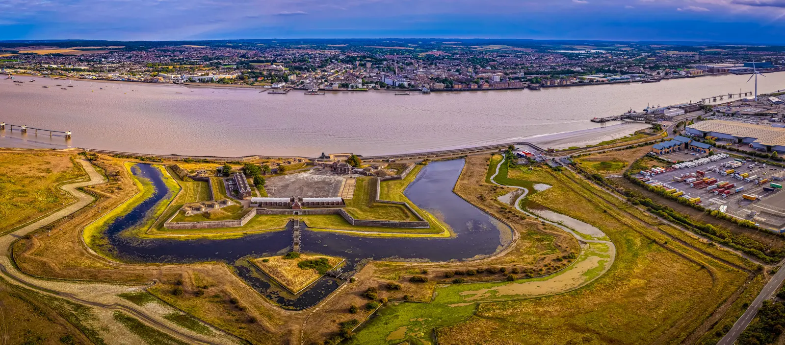 An aerial view of Tilbury Fort, a star-shaped bastioned artillery fort with double moats on the north bank of the River Thames in Essex