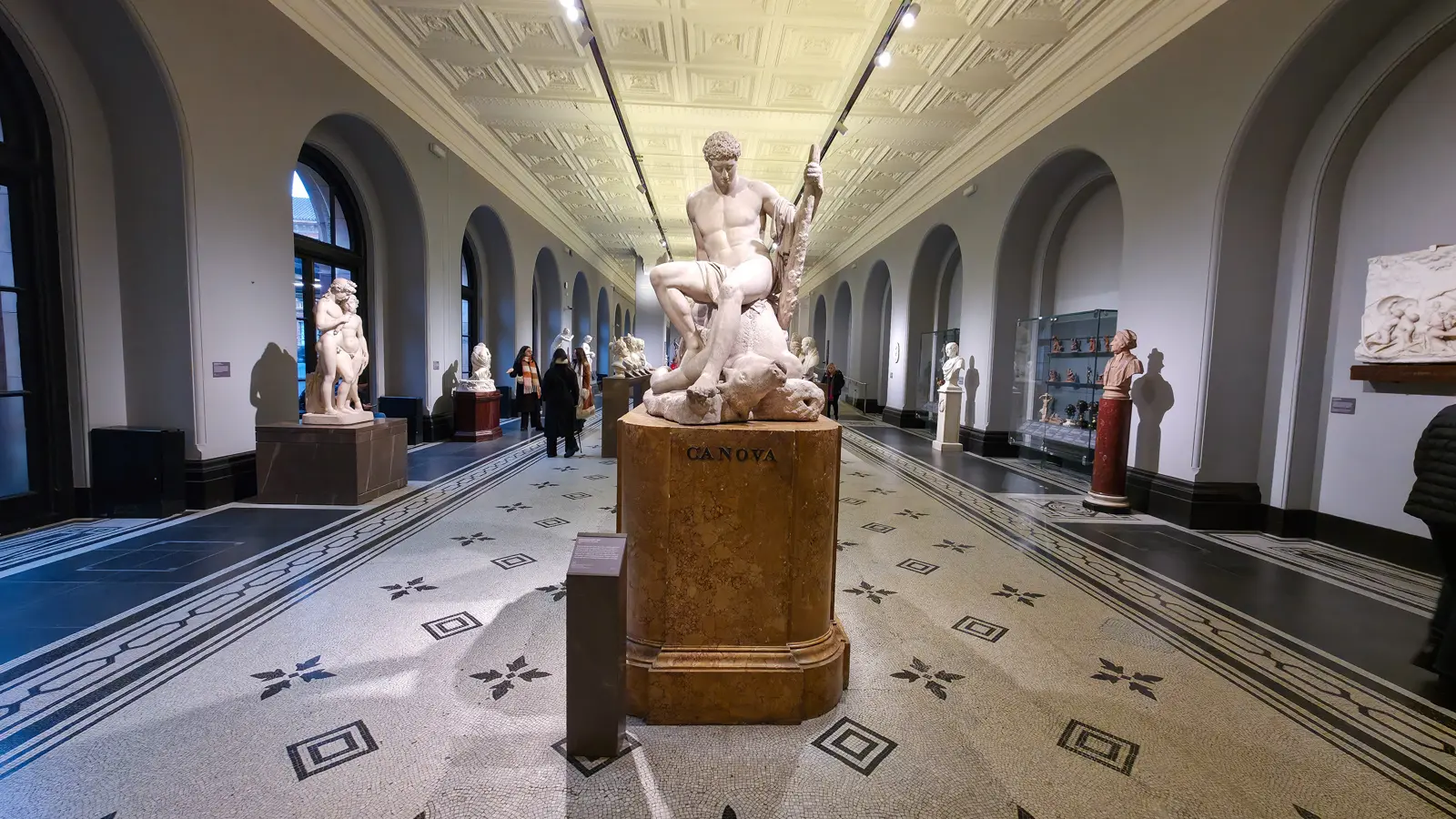 Antonio Canova's white marble Theseus and the Minotaur on a plinth marked Canova in the V&A's long sculpture gallery, London