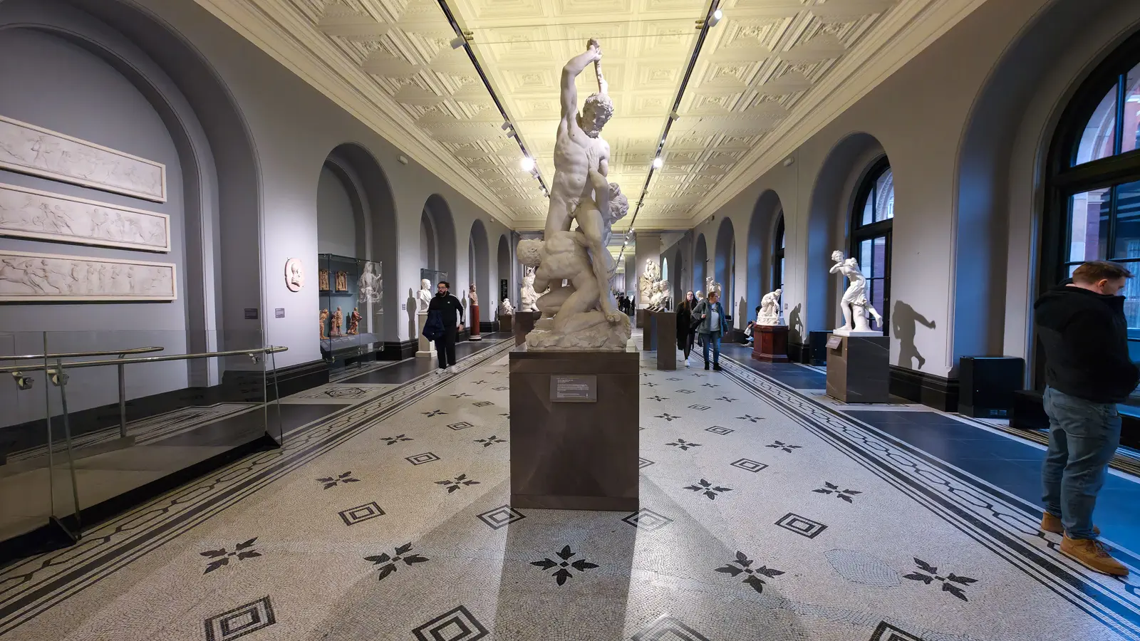 Giambologna's white marble Samson Slaying a Philistine, two intertwined figures, on a plinth in the V&A sculpture gallery, London
