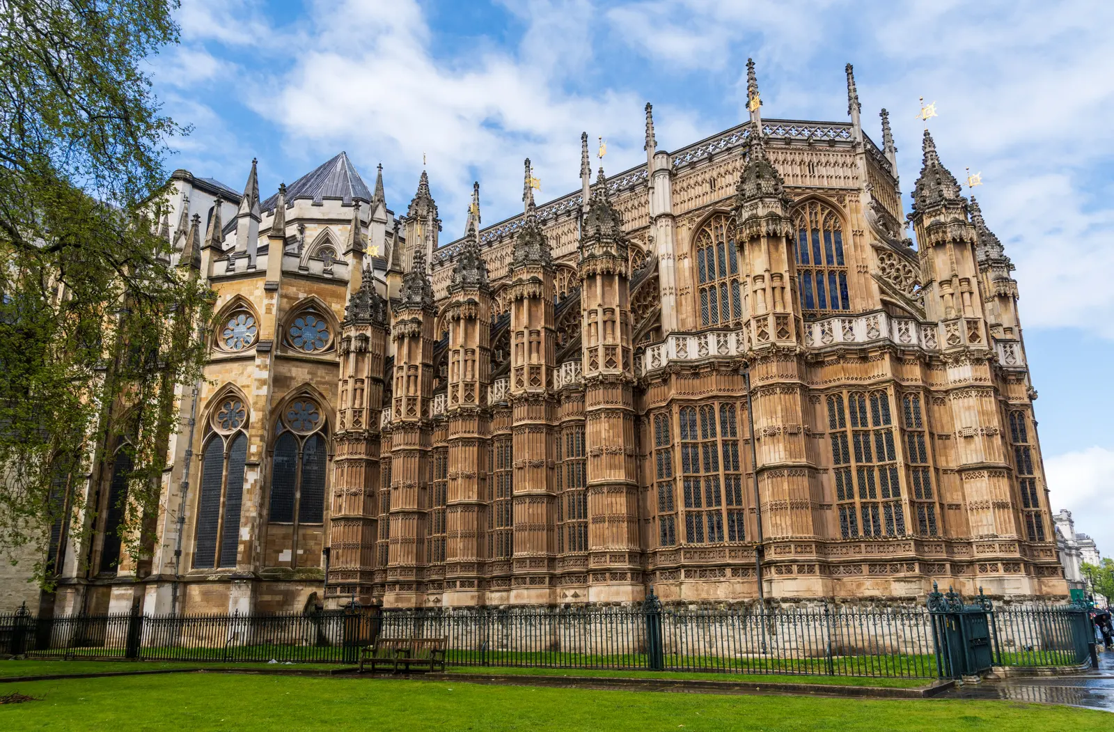 The east end of Westminster Abbey, the Henry VII Lady Chapel, a mass of pinnacles, tracery and tall windows above a green lawn