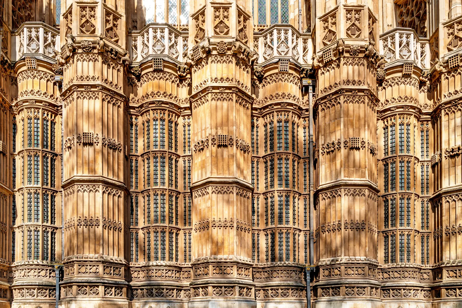 Close-up of the carved stone bay windows and dense Perpendicular tracery on the Henry VII Lady Chapel at Westminster Abbey
