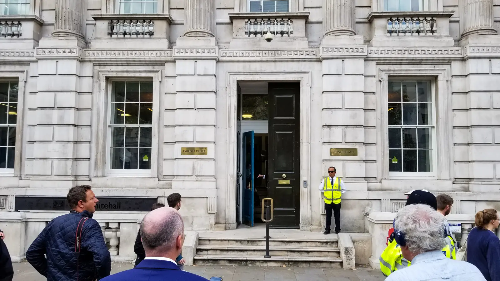 The Cabinet Office entrance at 70 Whitehall, with a doorman on the step, London