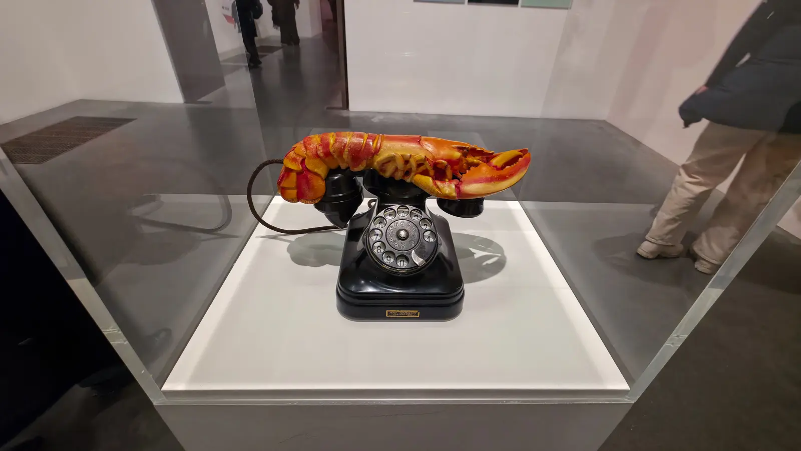 Salvador Dalí’s Lobster Telephone in a case at Tate Modern, a plaster lobster resting on the handset of a black rotary phone