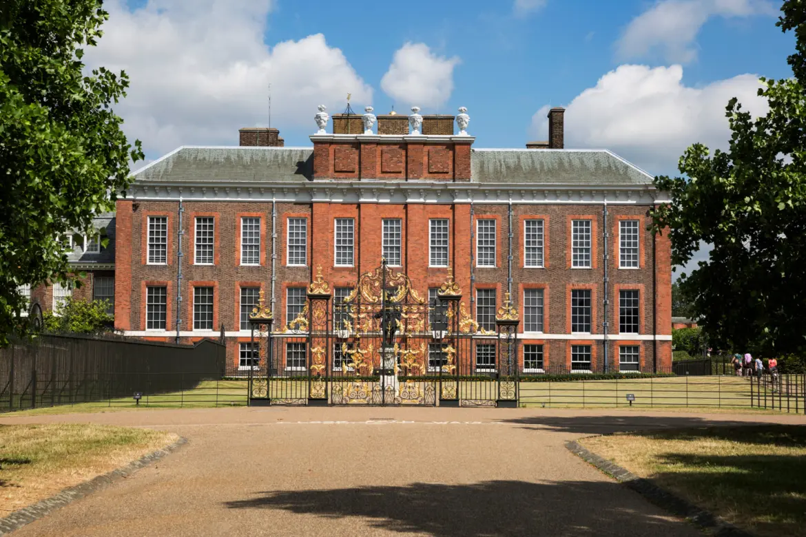 Kensington Palace, the red-brick London home of Diana, Princess of Wales, with its gilded gates, Kensington Gardens, London.