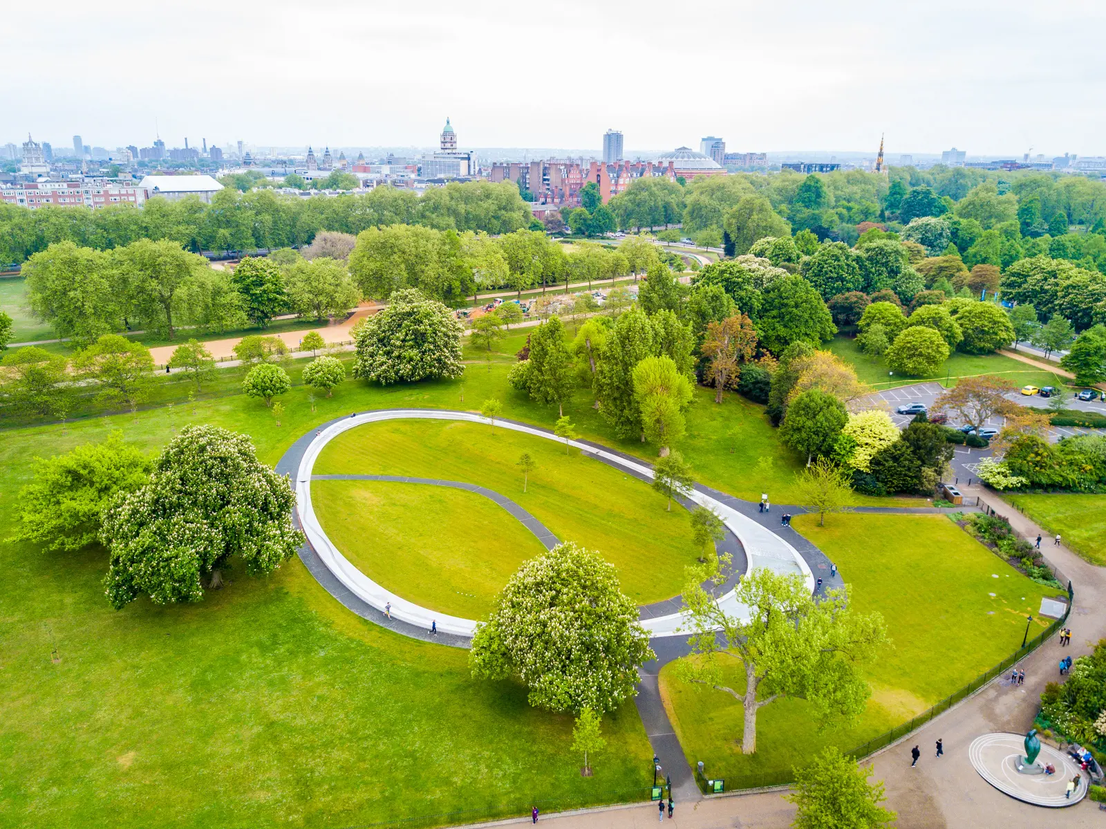 The Diana, Princess of Wales Memorial Fountain, an oval granite stream ring set into the grass of Hyde Park, seen from above, London.
