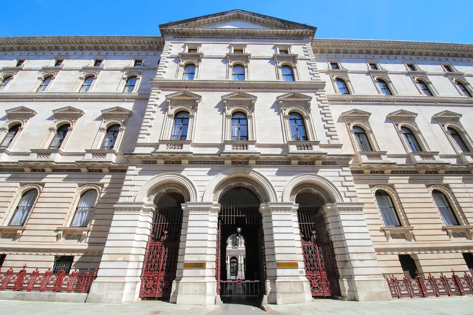 The grand Italianate frontage of the Foreign Office on King Charles Street, with its red iron gates, London