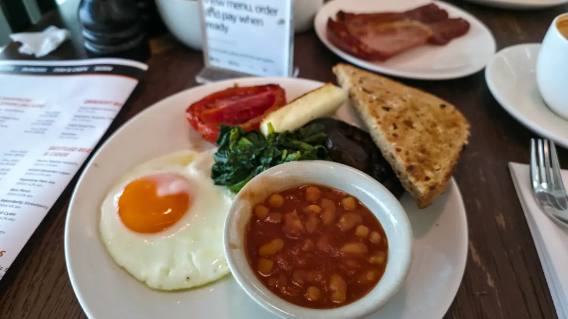 A full English breakfast at Gordon Ramsay Plane Food Market, Heathrow Terminal 5, with fried egg, beans, tomato, mushroom, spinach and toast