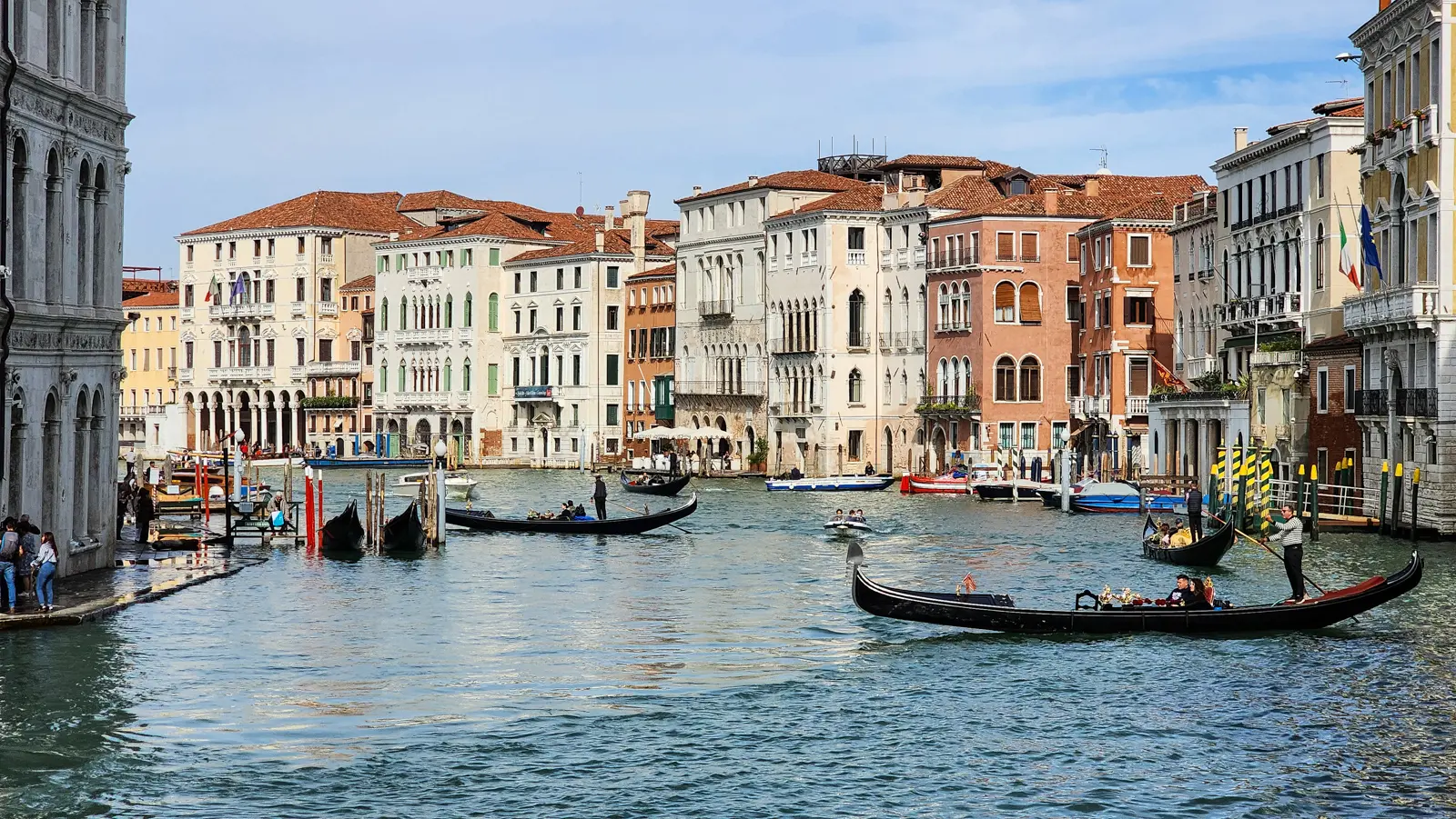 The Grand Canal lined with palazzi, gondolas carrying visitors past the waterfront, Venice