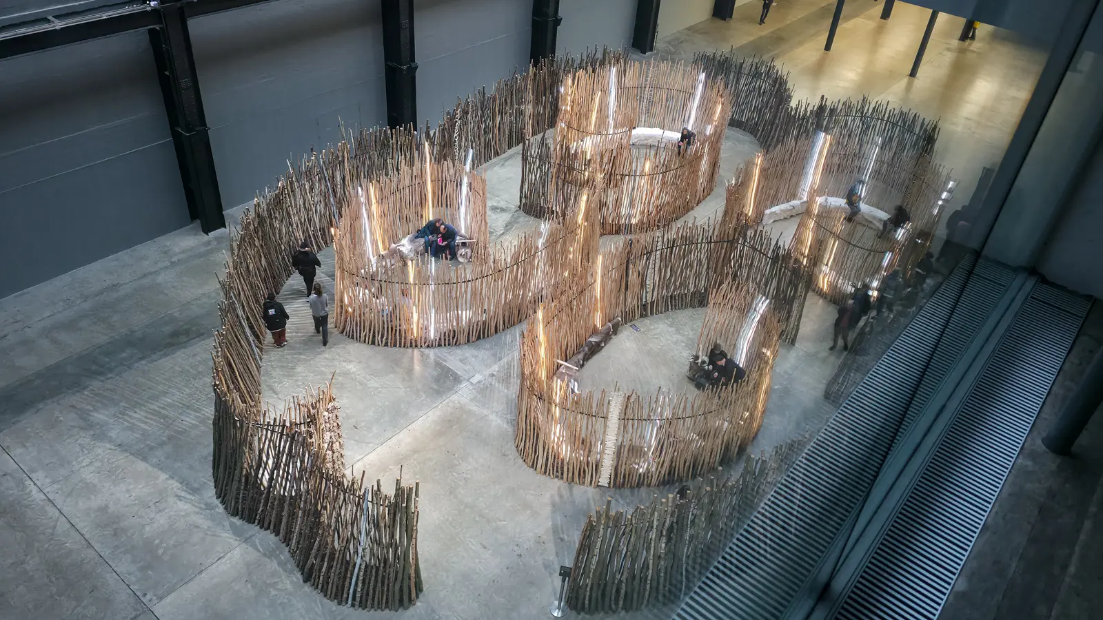 An elevated view across Máret Ánne Sara’s Goavve-Geabbil in the Turbine Hall at Tate Modern, showing the curve of the enclosures