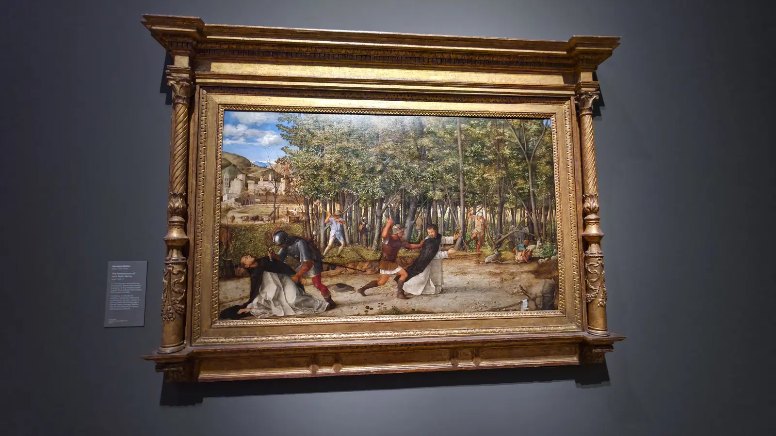 Giovanni Bellini's The Assassination of Saint Peter Martyr at the National Gallery, London, a Dominican friar struck down on a forest path while woodsmen fell trees behind.
