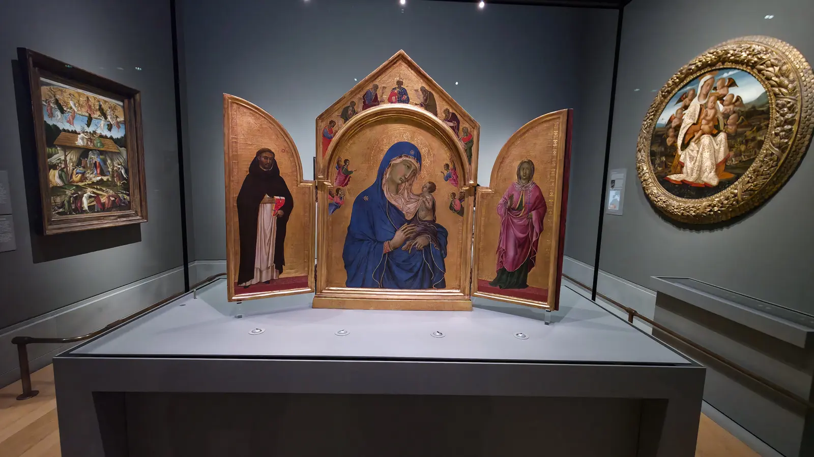 Duccio's small folding triptych of the Virgin and Child between Saint Dominic and Saint Aurea, shown open, National Gallery, London.