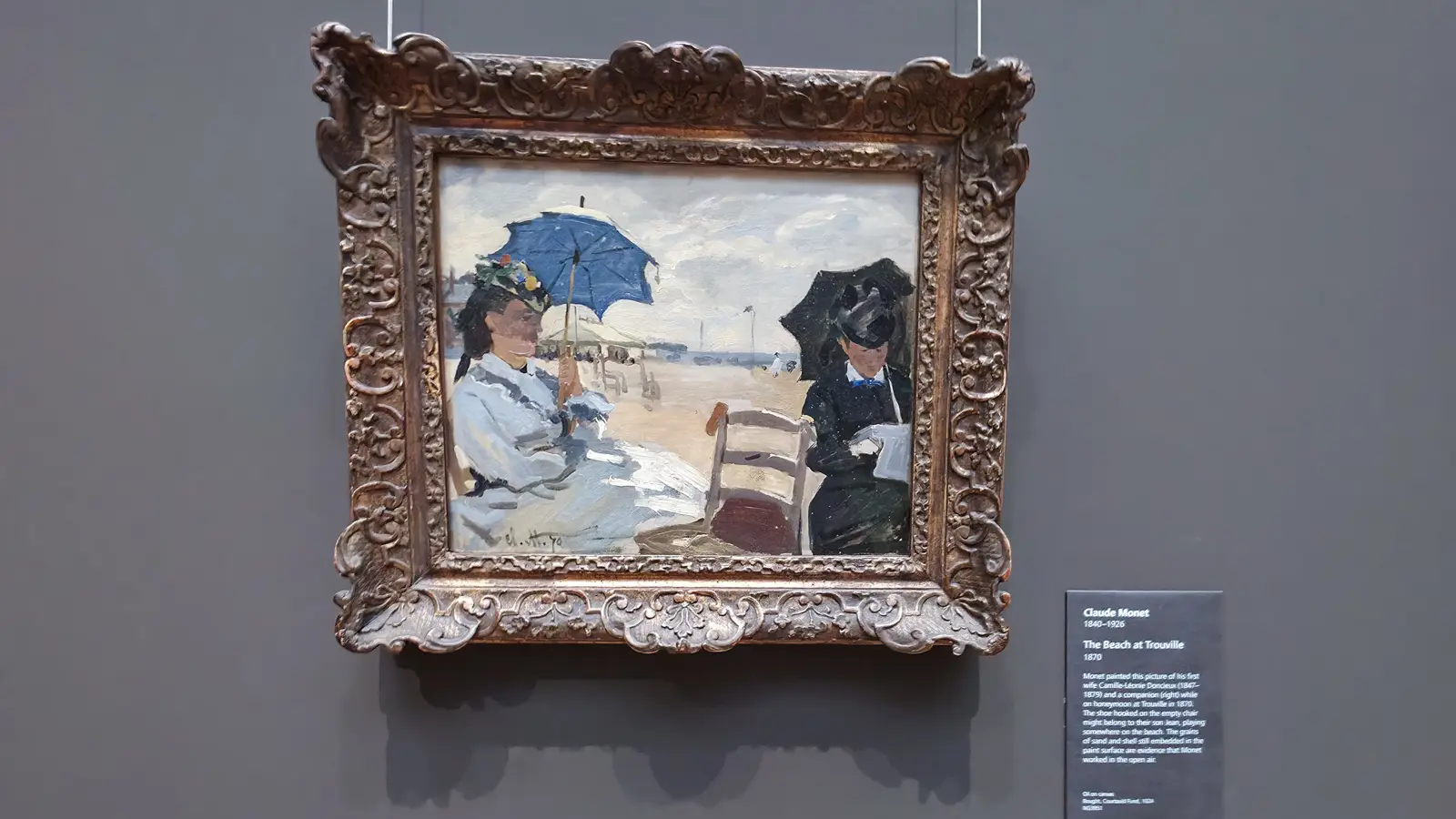 Monet's small painting The Beach at Trouville, two women with parasols on the sand, at the National Gallery, London