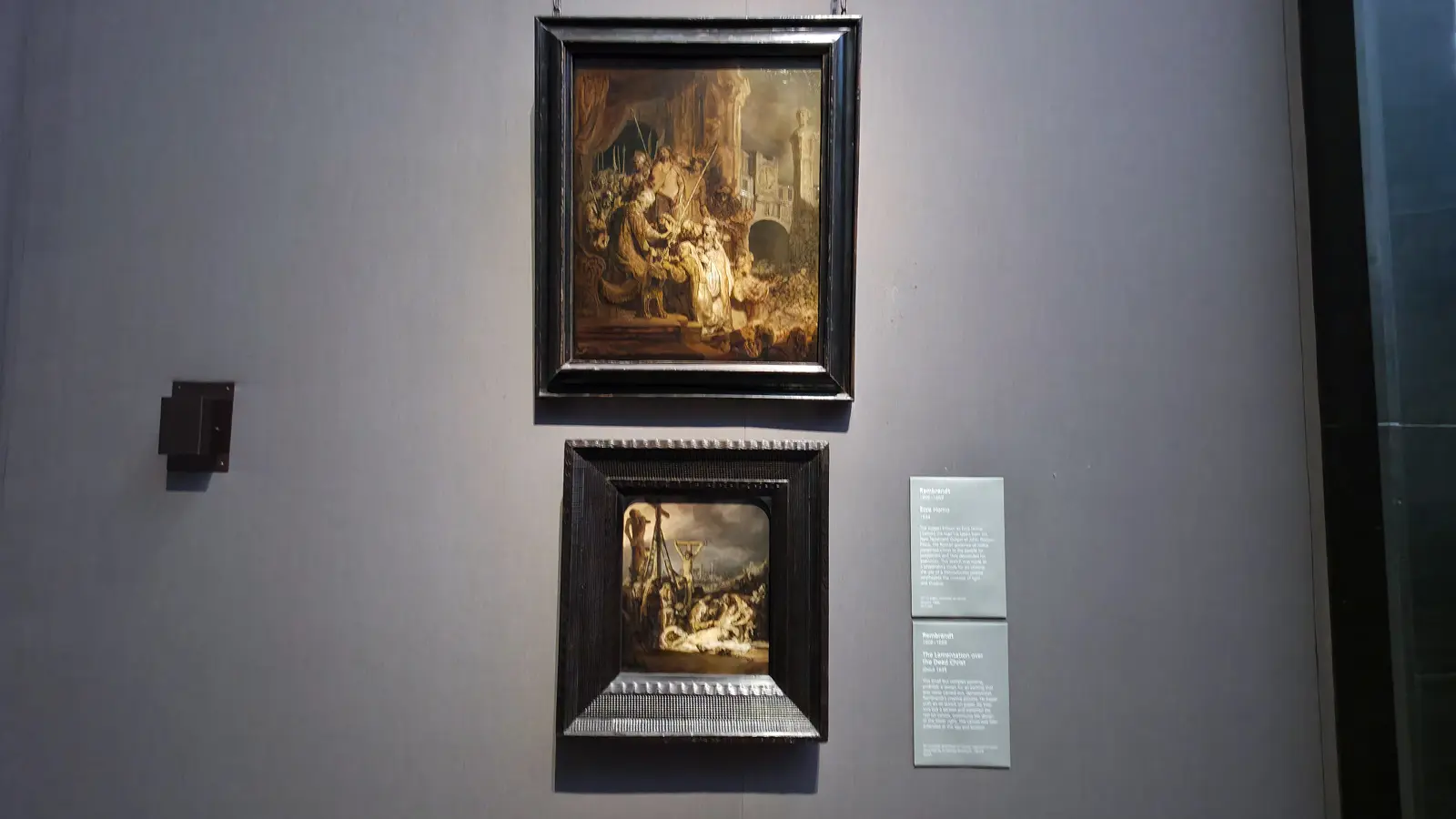 Two Rembrandt grisailles, Ecce Homo above and The Lamentation over the Dead Christ below, painted in shades of grey, National Gallery, London.