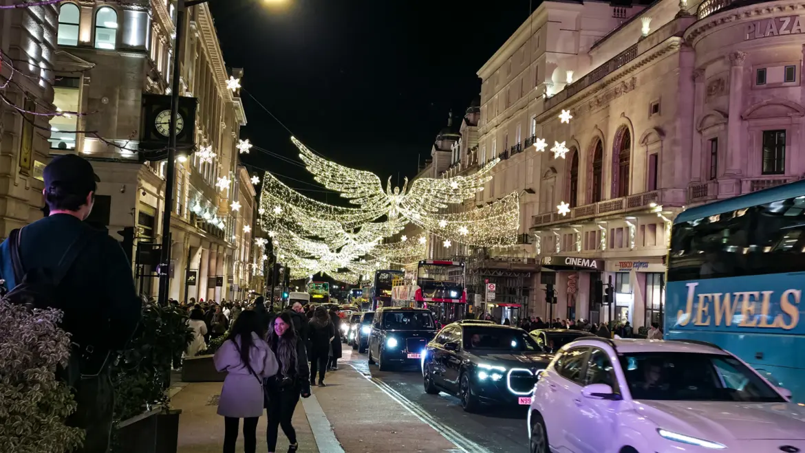 A giant illuminated angel with outstretched wings soaring above Regent Street at Christmas, London