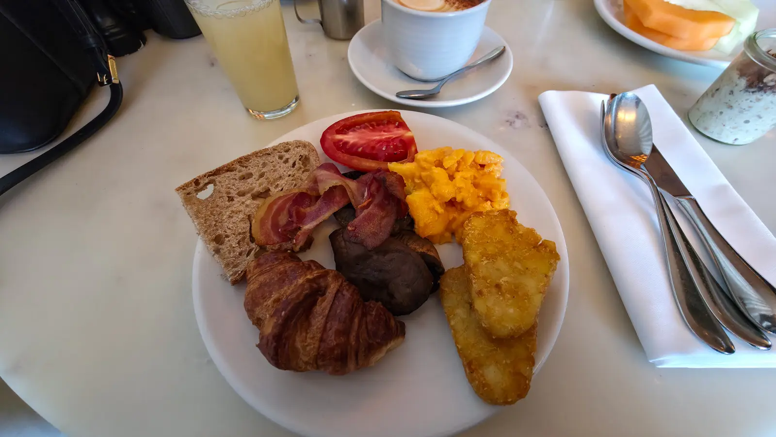 A breakfast plate at Sea Containers Restaurant: scrambled eggs, streaky bacon, mushroom, tomato, hash brown, sourdough and a croissant, South Bank London