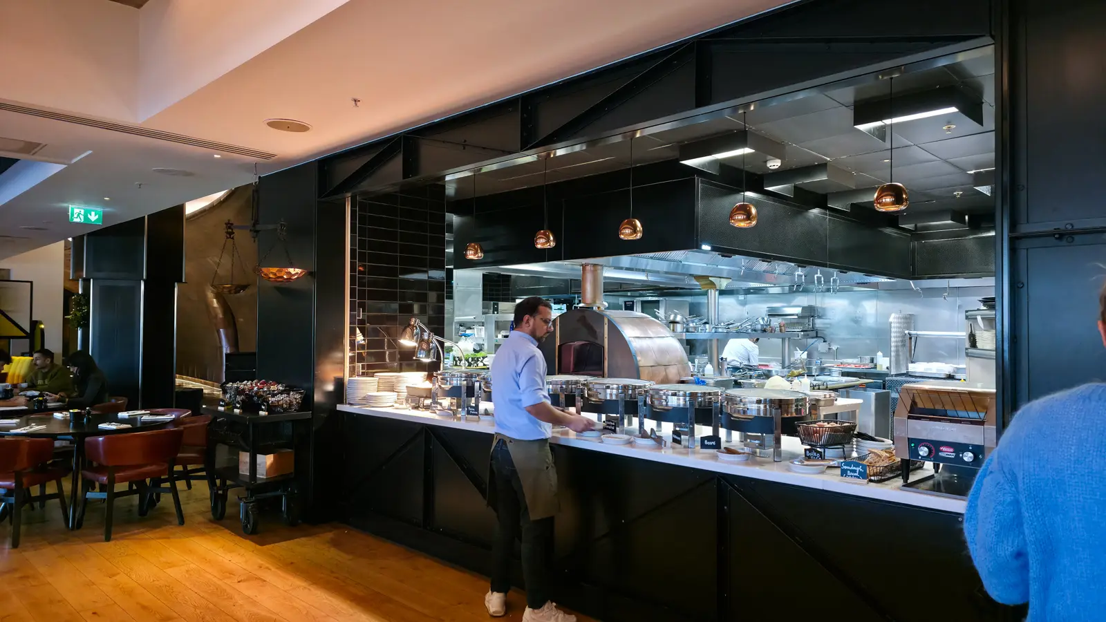 The hot buffet and open kitchen at Sea Containers Restaurant, with a wood-fired oven behind the chafing dishes, South Bank London
