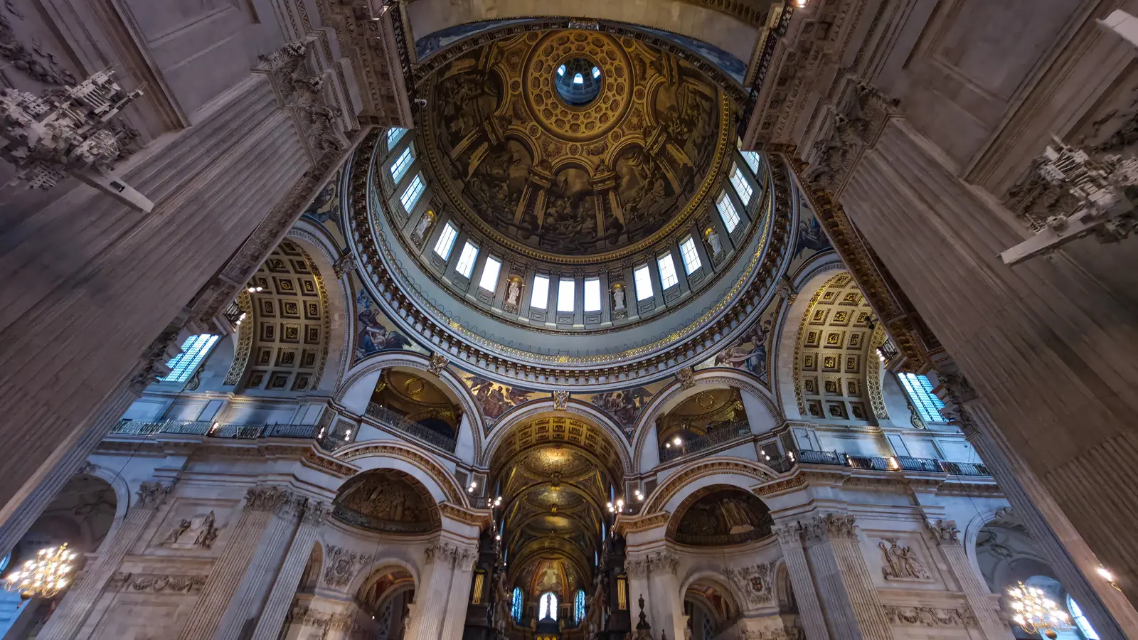 Looking up into the painted dome of St Paul’s Cathedral in London, with the Whispering Gallery below it and the oculus above