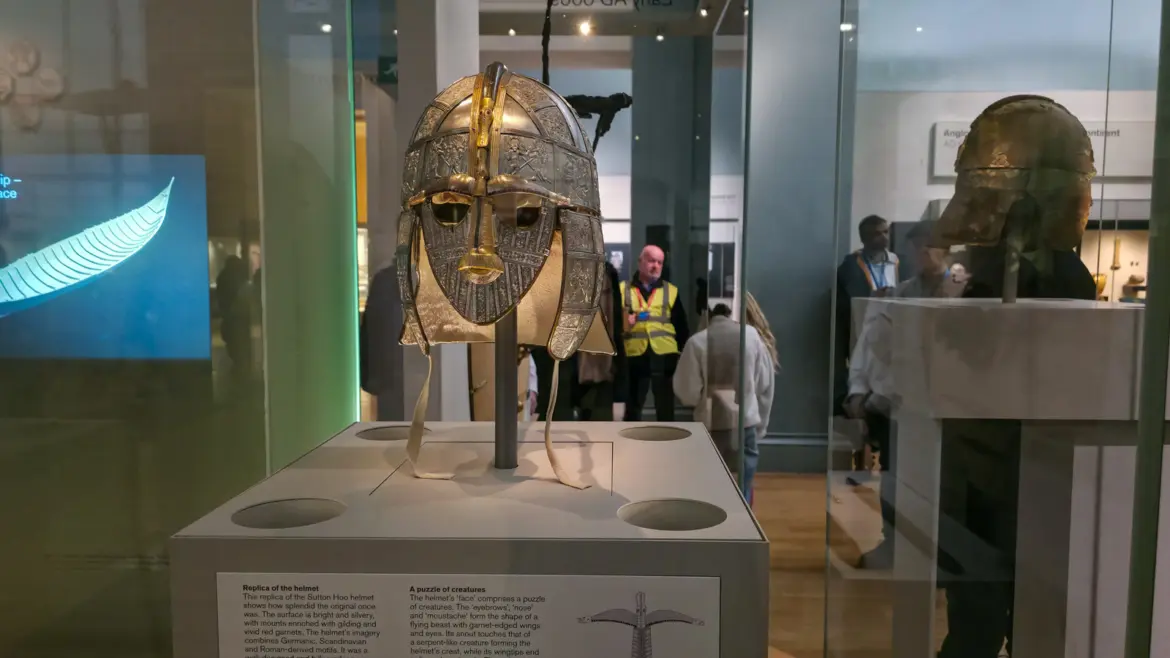The replica Sutton Hoo helmet, bright and silvery, in its glass case in Room 41 of the British Museum, London