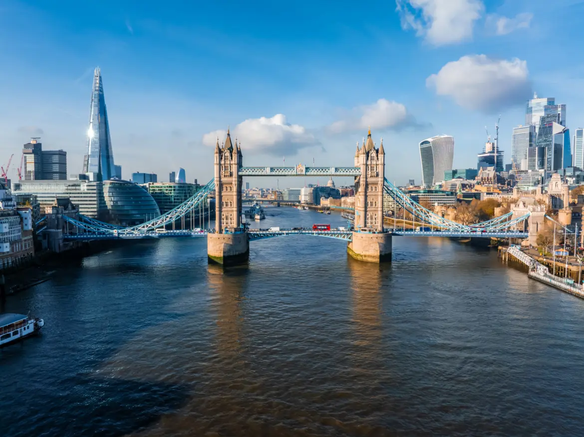 Tower Bridge from above with the Thames, the Shard and the City of London skyline behind it on a clear day