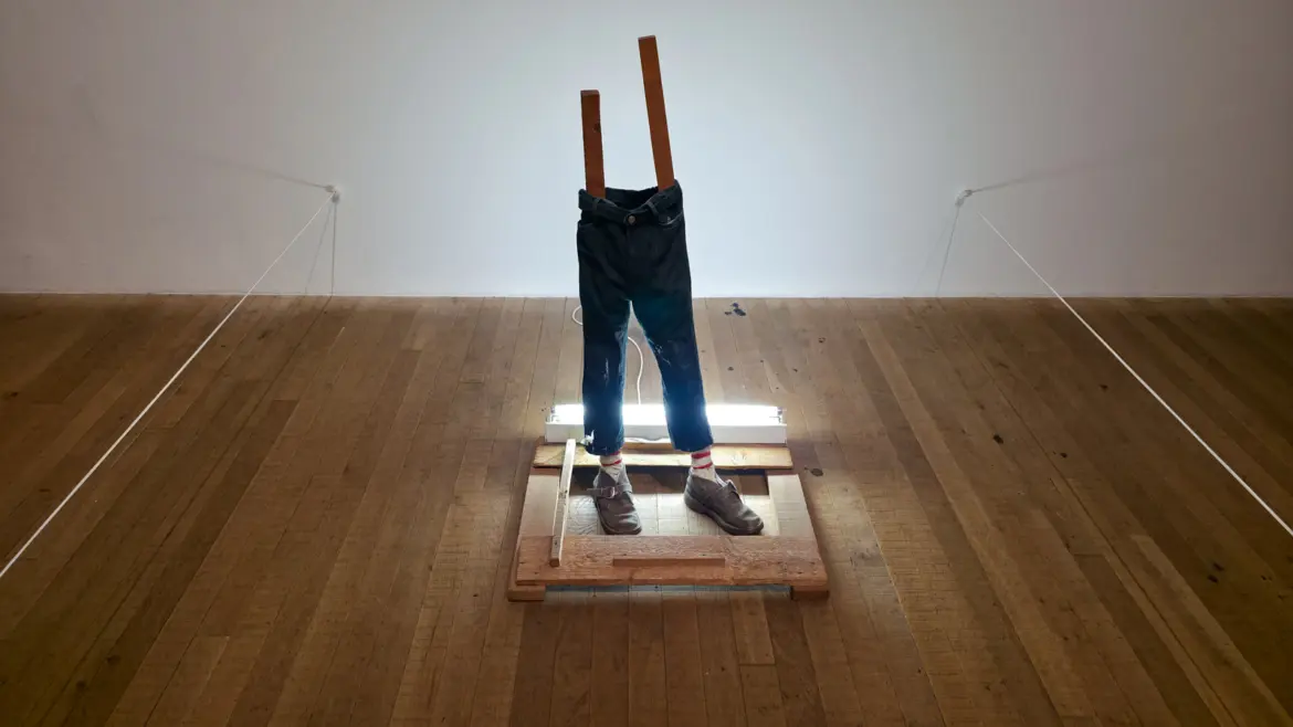 Vlassis Caniaris’s Untitled (1974) at Tate Modern, a faceless half-figure made of corduroy trousers and worn shoes on a wooden base