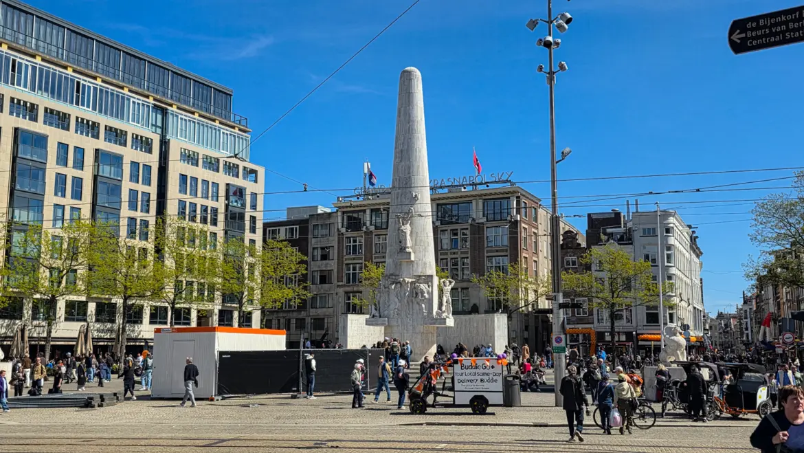 Dam Square, Amsterdam, with the National Monument, crowd barriers, a contractor’s container and orange bunting on the shopfronts