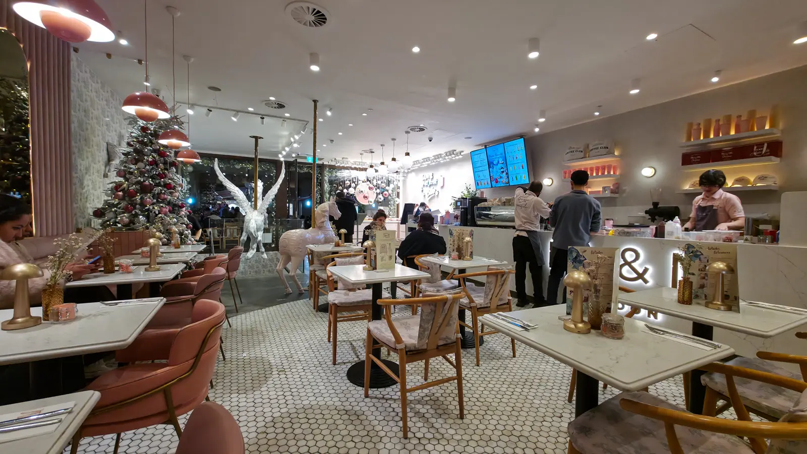 Inside EL&N, the pink London café, with its marble tables, blush chairs, a Christmas tree and a winged unicorn