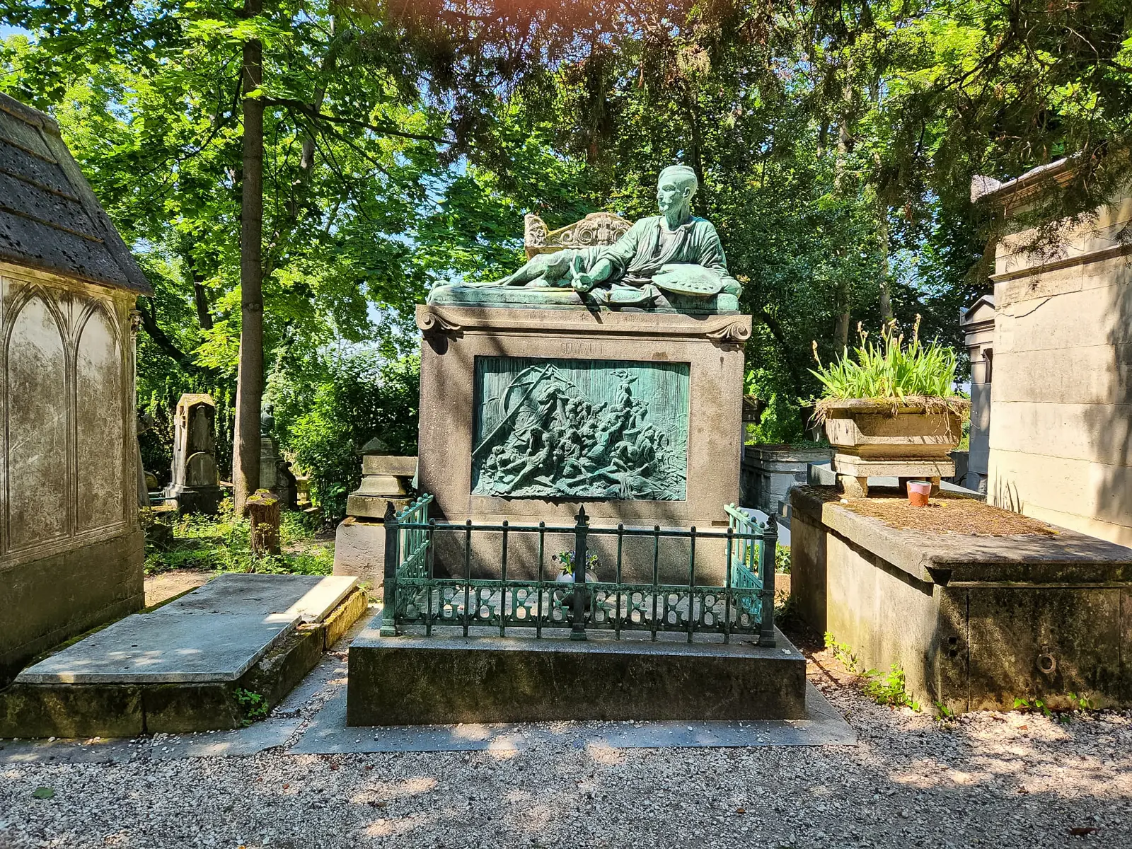 Géricault’s tomb at Père Lachaise, a bronze figure reclining with a palette above a relief of the Raft of the Medusa, behind green railings