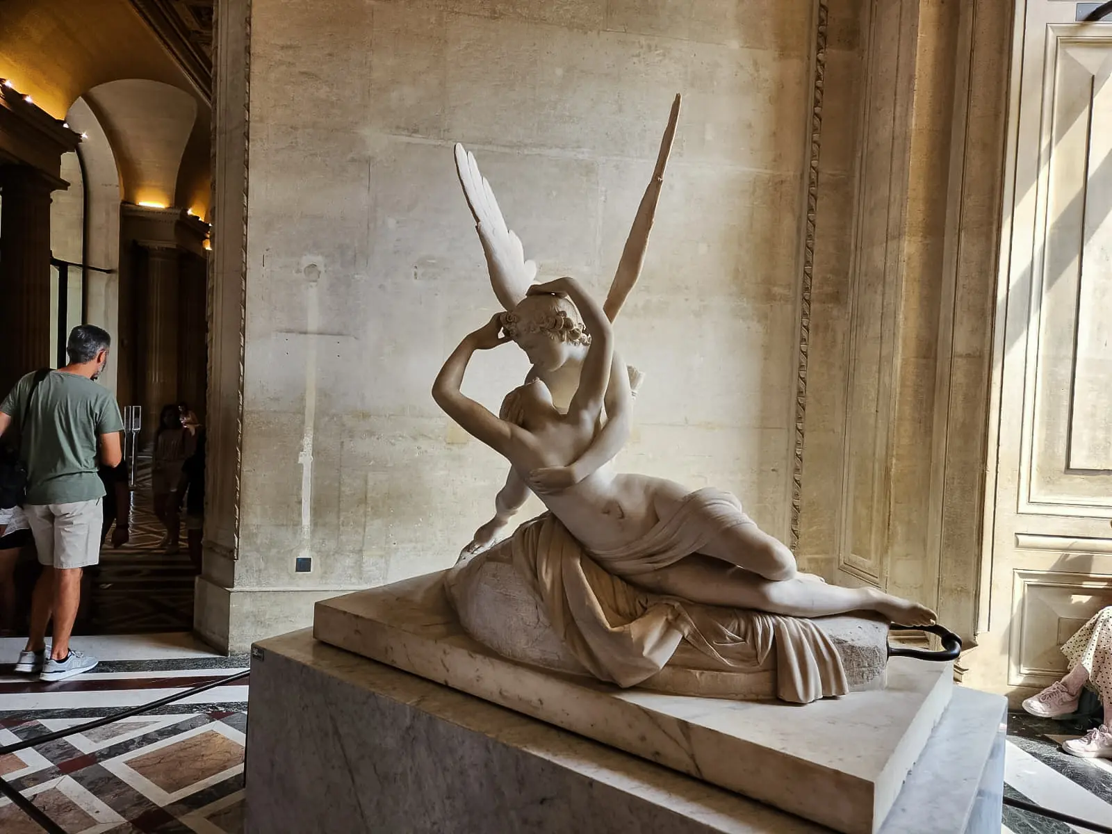 Canova’s marble sculpture of Cupid and Psyche at the Louvre, wings raised, the two figures caught in a curving embrace on a stone base