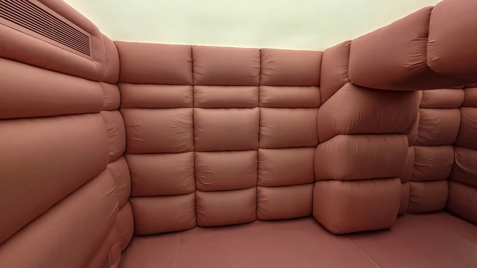 Take Over Elastic by Andrés Reisinger at Moco Museum Amsterdam, a room lined edge to edge with monumental soft pink inflatable forms